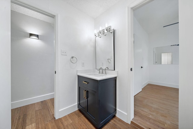 12239 Monticeto Ln, Meadows Place, TX 77477 - bathroom with wood finished floors, vanity, and a textured ceiling