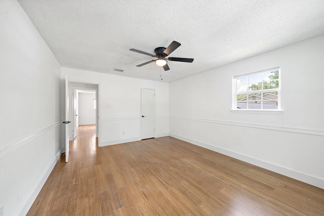 12239 Monticeto Ln, Meadows Place, TX 77477 - unfurnished bedroom featuring light wood-style floors, a textured ceiling, and ceiling fan