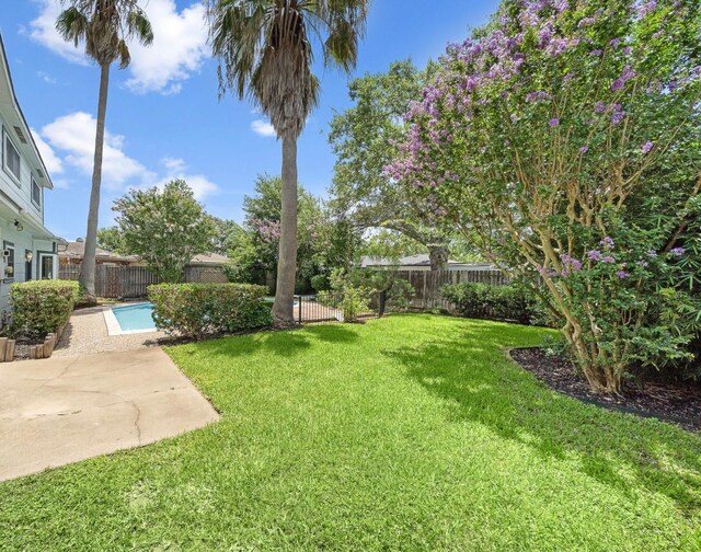 12239 Monticeto Ln, Meadows Place, TX 77477 - fenced backyard with a patio area