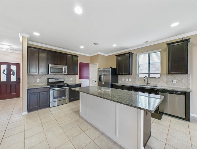 20015 Flax Flower Dr, Richmond, TX 77407 - kitchen featuring appliances with stainless steel finishes, recessed lighting, decorative backsplash, dark stone countertops, and dark brown cabinets