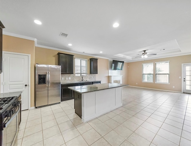 20015 Flax Flower Dr, Richmond, TX 77407 - kitchen featuring stainless steel fridge, range with gas cooktop, decorative backsplash, crown molding, and ceiling fan