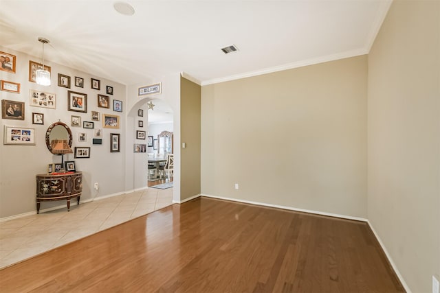 18115 Stone Angel Dr, Humble, TX 77346 - unfurnished room featuring arched walkways, wood finished floors, and ornamental molding