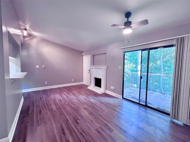 3500 Tangle Brush Dr Unit 1, The Woodlands, TX 77381 - unfurnished living room with dark wood-style flooring, a brick fireplace, and a ceiling fan