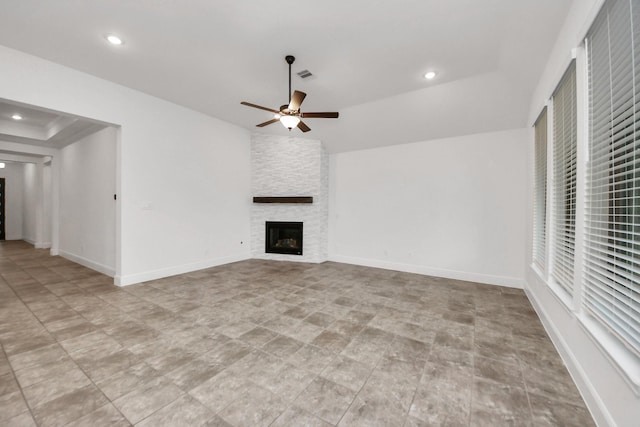 14807 Providence Manor Way, Cypress, TX 77429 - unfurnished living room featuring a ceiling fan, a stone fireplace, and recessed lighting
