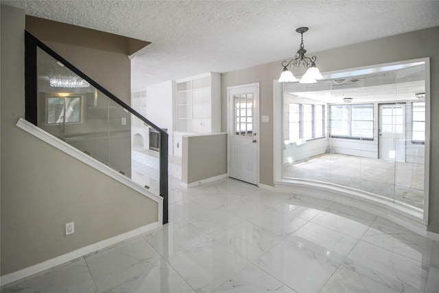 15102 Torry Pines Rd, Houston, TX 77062 - foyer with marble finish flooring, a textured ceiling, and a chandelier