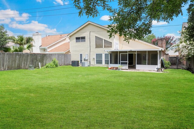 12223 Gladewick Dr, Houston, TX 77077 - back of property with a fenced backyard, a sunroom, and a chimney