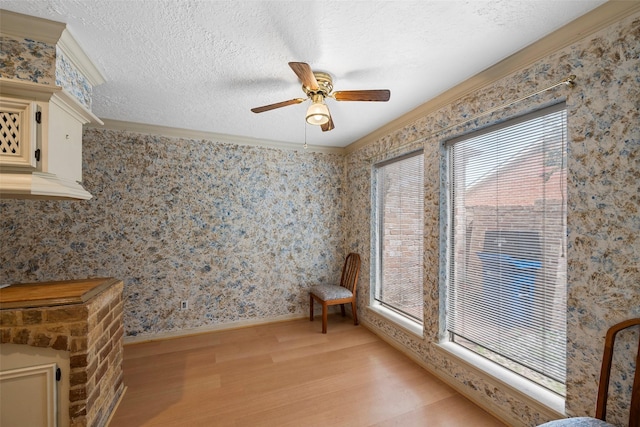 12223 Gladewick Dr, Houston, TX 77077 - unfurnished room featuring light wood-style flooring, crown molding, ceiling fan, wallpapered walls, and a textured ceiling