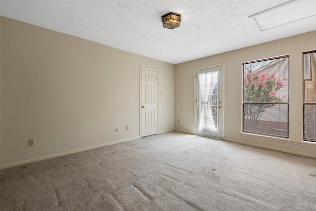 12223 Gladewick Dr, Houston, TX 77077 - spare room with carpet flooring, a textured ceiling, and attic access