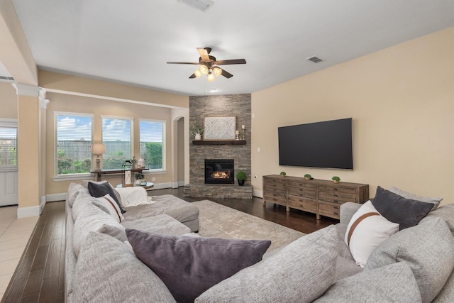12919 Arlington Meadows Ln, Tomball, TX 77377 - living area featuring a ceiling fan, healthy amount of natural light, wood finished floors, and a stone fireplace