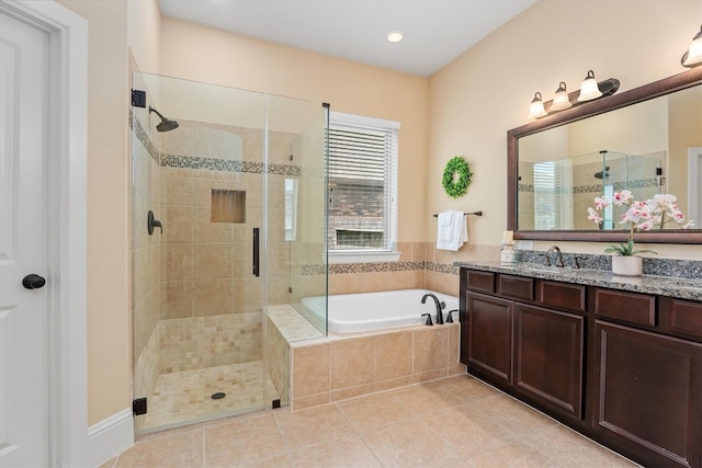 12919 Arlington Meadows Ln, Tomball, TX 77377 - full bathroom with vanity, a shower stall, a garden tub, tile patterned floors, and recessed lighting