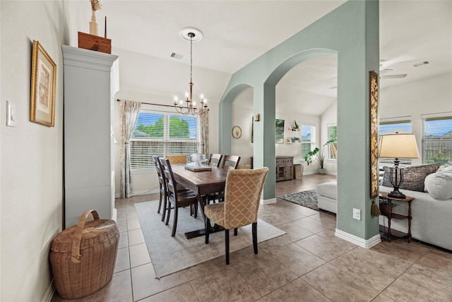 20206 Fossil Valley Ln, Cypress, TX 77433 - dining room featuring arched walkways, a chandelier, light tile patterned floors, and lofted ceiling