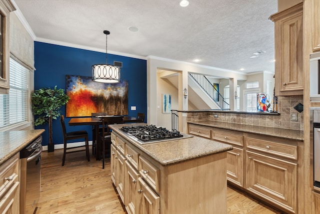 5706 Blossom St, Houston, TX 77007 - kitchen with stainless steel appliances, healthy amount of natural light, a textured ceiling, a kitchen island, and light wood-type flooring