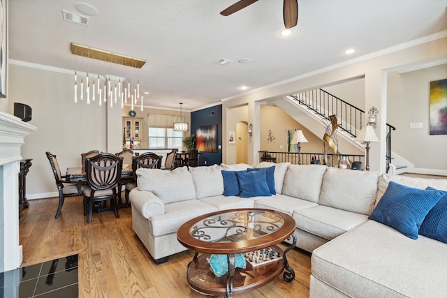 5706 Blossom St, Houston, TX 77007 - living room with a ceiling fan, ornamental molding, stairway, recessed lighting, and wood finished floors