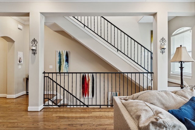 5706 Blossom St, Houston, TX 77007 - stairway with wood finished floors, arched walkways, and ornamental molding
