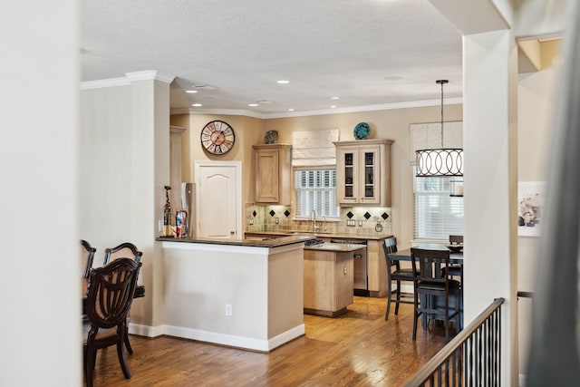 5706 Blossom St, Houston, TX 77007 - kitchen featuring decorative backsplash, light wood-type flooring, recessed lighting, glass insert cabinets, and ornamental molding
