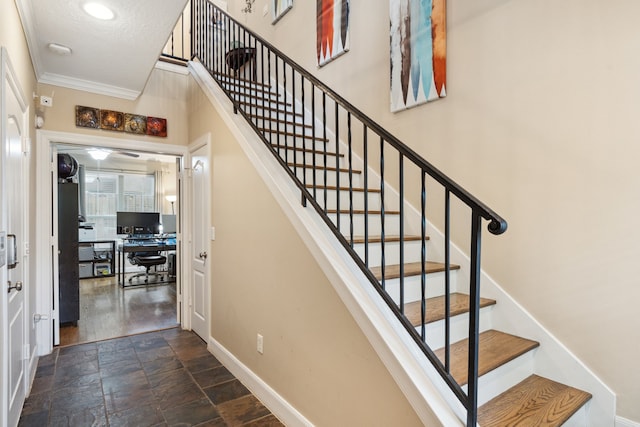 5706 Blossom St, Houston, TX 77007 - stairs featuring ornamental molding, stone finish flooring, and a textured ceiling