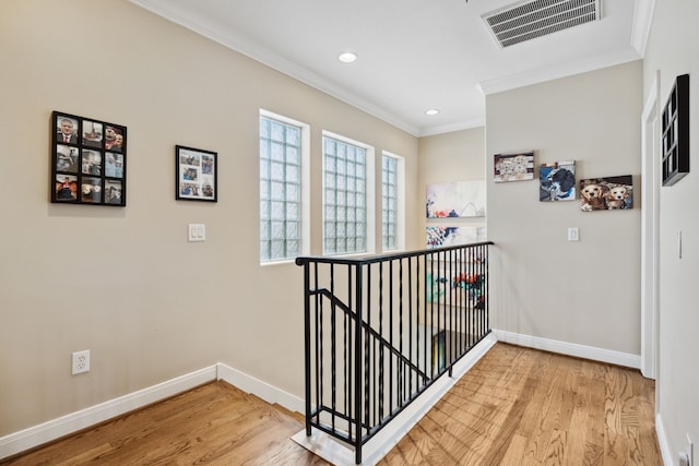 5706 Blossom St, Houston, TX 77007 - hallway featuring an upstairs landing, light wood-style flooring, ornamental molding, and recessed lighting