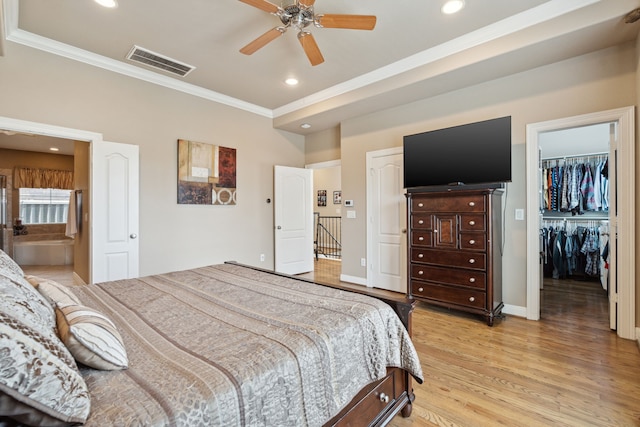 5706 Blossom St, Houston, TX 77007 - bedroom with ornamental molding, light wood finished floors, recessed lighting, a spacious closet, and ensuite bath