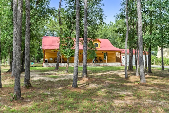4214 Cross Cut, Cleveland, TX 77328 - view of front facade with covered porch, faux log siding, and a metal roof