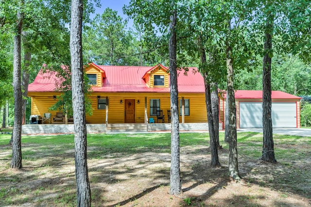 4214 Cross Cut, Cleveland, TX 77328 - view of front of house with a porch, a garage, a metal roof, and an outdoor structure