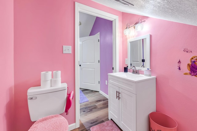 4214 Cross Cut, Cleveland, TX 77328 - half bathroom with vanity, wood finished floors, and a textured ceiling