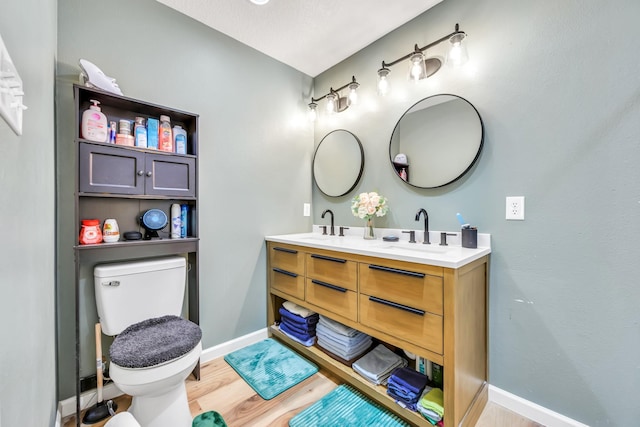 4214 Cross Cut, Cleveland, TX 77328 - bathroom featuring wood finished floors and double vanity