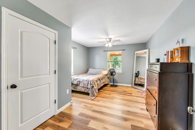 4214 Cross Cut, Cleveland, TX 77328 - bedroom featuring light wood finished floors, a ceiling fan, and a textured ceiling
