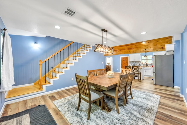 4214 Cross Cut, Cleveland, TX 77328 - dining area with recessed lighting, stairway, light wood-style flooring, and a chandelier