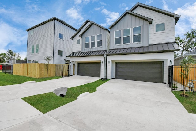 2610 Vance St, Houston, TX 77093 - view of front of property featuring a garage, concrete driveway, board and batten siding, and a standing seam roof
