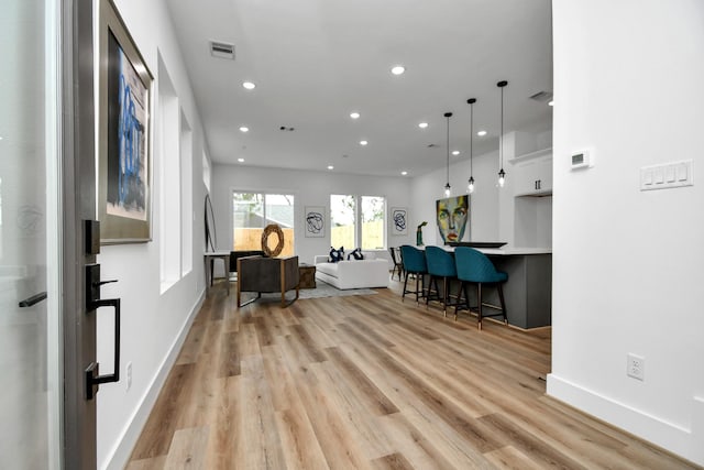 2610 Vance St, Houston, TX 77093 - kitchen with recessed lighting, a kitchen breakfast bar, light wood-type flooring, hanging light fixtures, and light countertops