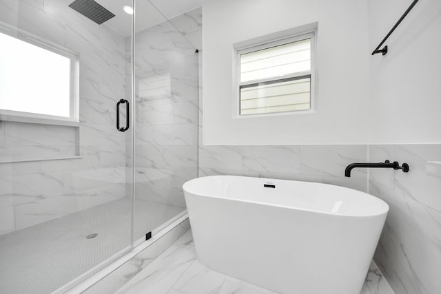 1218 English St, Houston, TX 77009 - full bath featuring marble look tile flooring, healthy amount of natural light, a freestanding tub, a marble finish shower, and a wainscoted wall