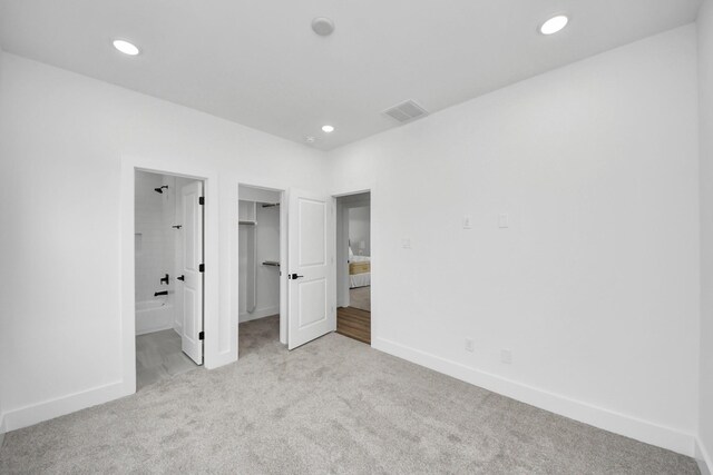 1218 English St, Houston, TX 77009 - unfurnished bedroom with carpet flooring, a walk in closet, recessed lighting, and ensuite bath