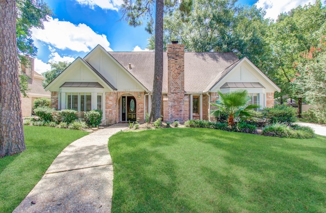 3623 Beech Hill Dr, Spring, TX 77388 - view of front of house with a front yard, brick siding, and a chimney
