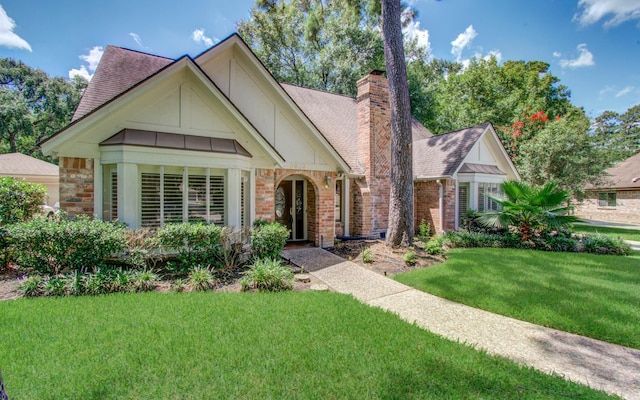 3623 Beech Hill Dr, Spring, TX 77388 - view of front of house with a shingled roof, a front lawn, a chimney, brick siding, and board and batten siding