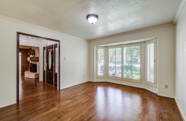 3623 Beech Hill Dr, Spring, TX 77388 - empty room featuring dark wood finished floors, a textured ceiling, crown molding, and a fireplace