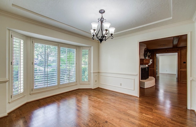 3623 Beech Hill Dr, Spring, TX 77388 - empty room featuring a chandelier, wood finished floors, crown molding, a decorative wall, and a brick fireplace