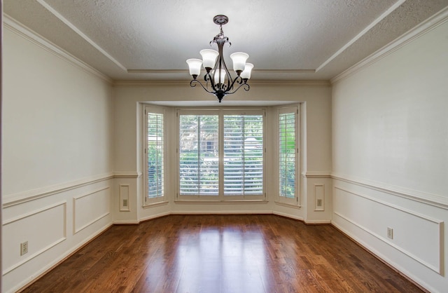 3623 Beech Hill Dr, Spring, TX 77388 - empty room with a chandelier, dark wood finished floors, a textured ceiling, a wainscoted wall, and a decorative wall