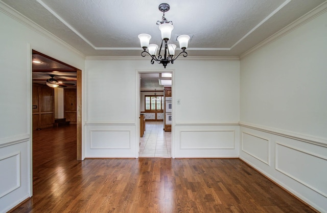 3623 Beech Hill Dr, Spring, TX 77388 - unfurnished dining area featuring a chandelier, a decorative wall, wood finished floors, crown molding, and a textured ceiling