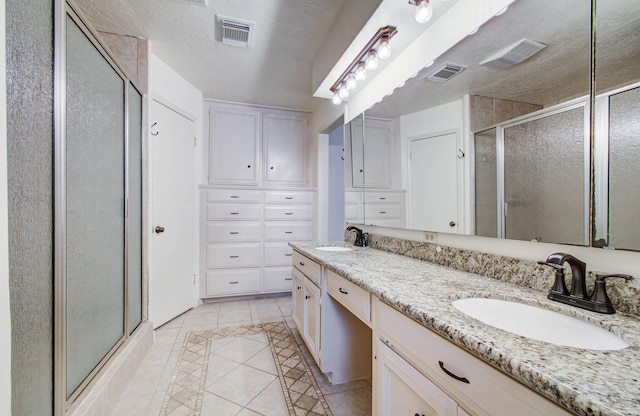 3623 Beech Hill Dr, Spring, TX 77388 - bathroom with tile patterned floors, a stall shower, double vanity, and inlaid floor details
