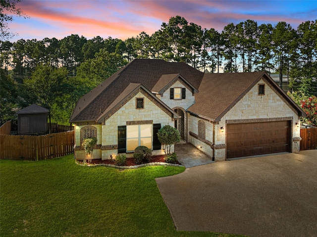 1207 Marigold Ln, Longview, TX 75604 - french country inspired facade featuring stone siding, asphalt driveway, an attached garage, and a shingled roof
