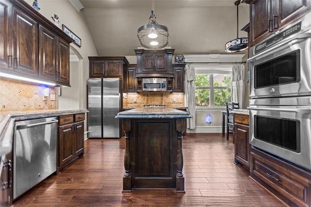 1207 Marigold Ln, Longview, TX 75604 - kitchen featuring stainless steel appliances, dark brown cabinets, a center island, light stone counters, and tasteful backsplash