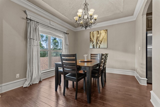 1207 Marigold Ln, Longview, TX 75604 - dining area featuring a chandelier, dark wood finished floors, ornamental molding, and a textured ceiling