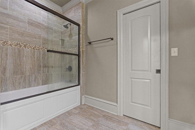 1207 Marigold Ln, Longview, TX 75604 - bathroom with shower / bath combination with glass door and baseboards