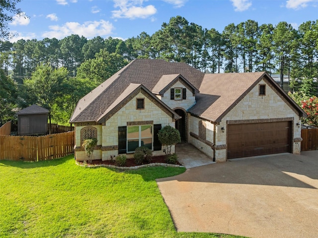 1207 Marigold Ln, Longview, TX 75604 - french country style house featuring stone siding, a garage, driveway, and a shingled roof