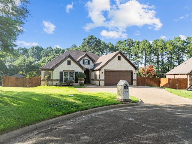 1207 Marigold Ln, Longview, TX 75604 - view of front of house featuring stone siding, a garage, and driveway