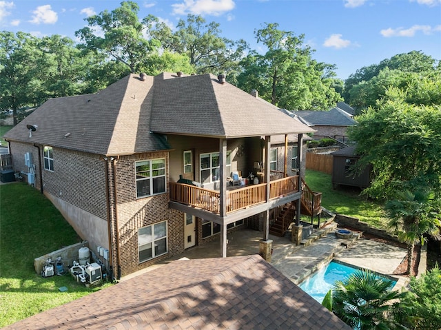 1207 Marigold Ln, Longview, TX 75604 - rear view of house with a wooden deck, stairway, a patio, brick siding, and a shingled roof