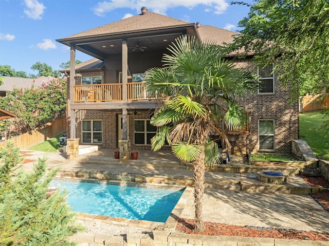1207 Marigold Ln, Longview, TX 75604 - back of property featuring brick siding, a patio, a balcony, a ceiling fan, and an outdoor fire pit