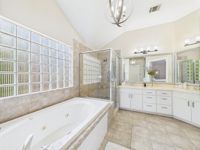 5810 Darling St Unit F, Houston, TX 77007 - full bath featuring double vanity, a tub with jets, a stall shower, lofted ceiling, and a chandelier