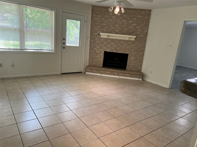23114 Earlmist Dr, Spring, TX 77373 - unfurnished living room with a ceiling fan, a fireplace, and light tile patterned floors
