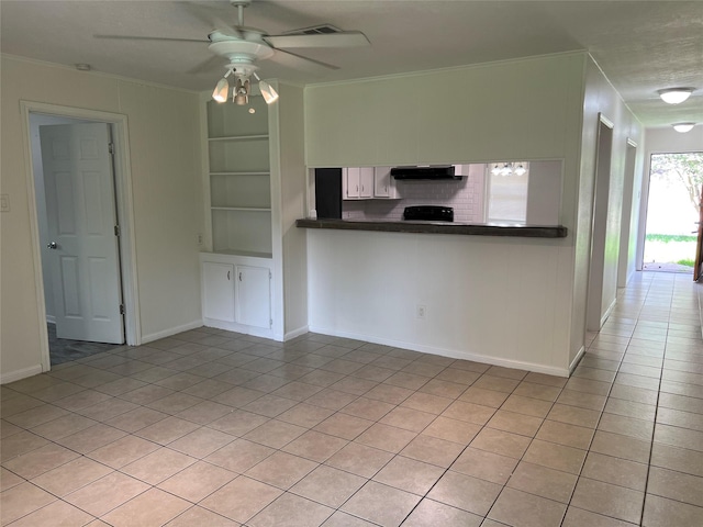 23114 Earlmist Dr, Spring, TX 77373 - unfurnished living room featuring light tile patterned floors, a ceiling fan, crown molding, and built in features
